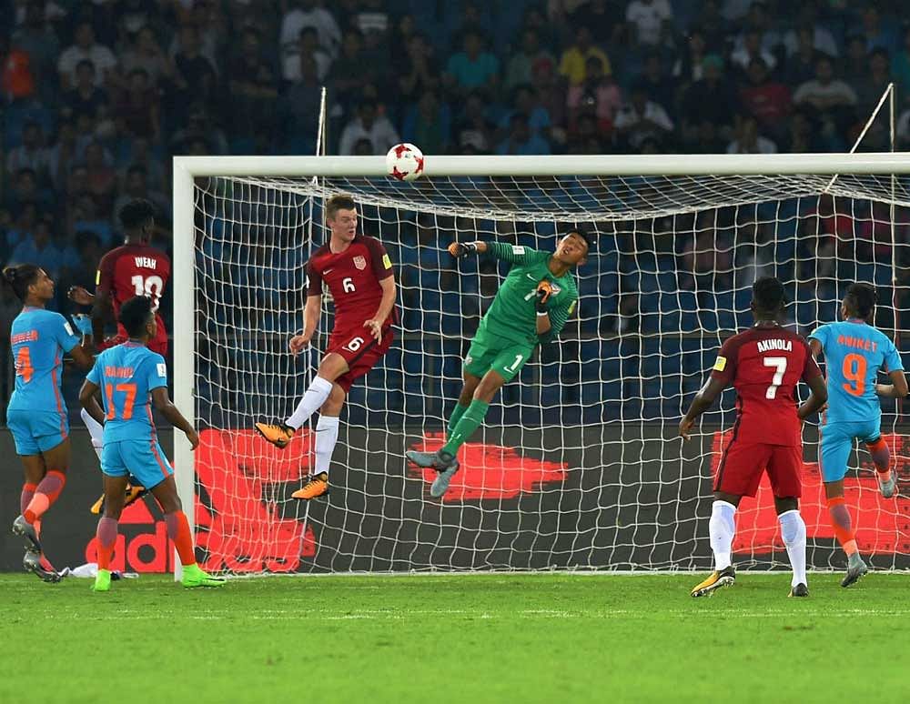 Indian goalkeeper Dheeraj Moirangthem saves a goal during their U-17 FIFA World Cup football match against USA in New Delhi. Despite their preparation, India lost to the USA 0-3. PTI photo.
