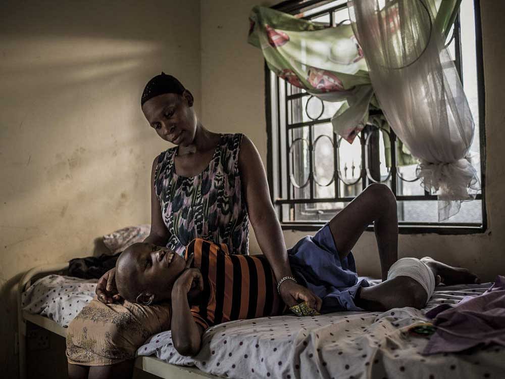 Ratibu Asiligwa, 10, takes morphine to alleviate the pain from a cancer of skeletal muscle cells, at Kawempe Home Care in Kampala, Uganda. Cancer now kills about 4,50,000 Africans a year. By 2030, it will kill almost 1 million annually, the WHO predicts. nyt
