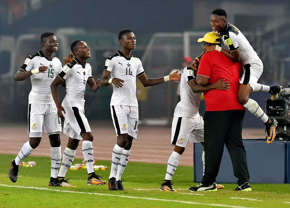 Ghana's players celebrates a goal with his coach against India during their U-17 FIFA World cup football match in New Delhi. PTI photo.