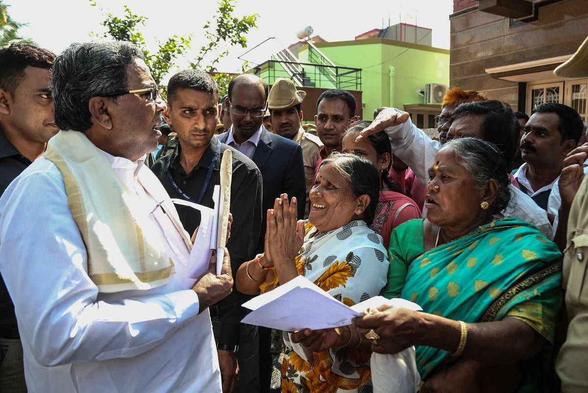 Chief Minister Siddaramaiah listening to the problems of people during Janatha Darshan, at his residence, Sharadadevi Nagara in Mysuru on Monday October 30, 2017