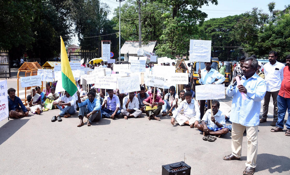 Koraga Abhivriddhi Sanghagala Okkoota members stage a protest, in front of DC's office, in Mangaluru on Monday.