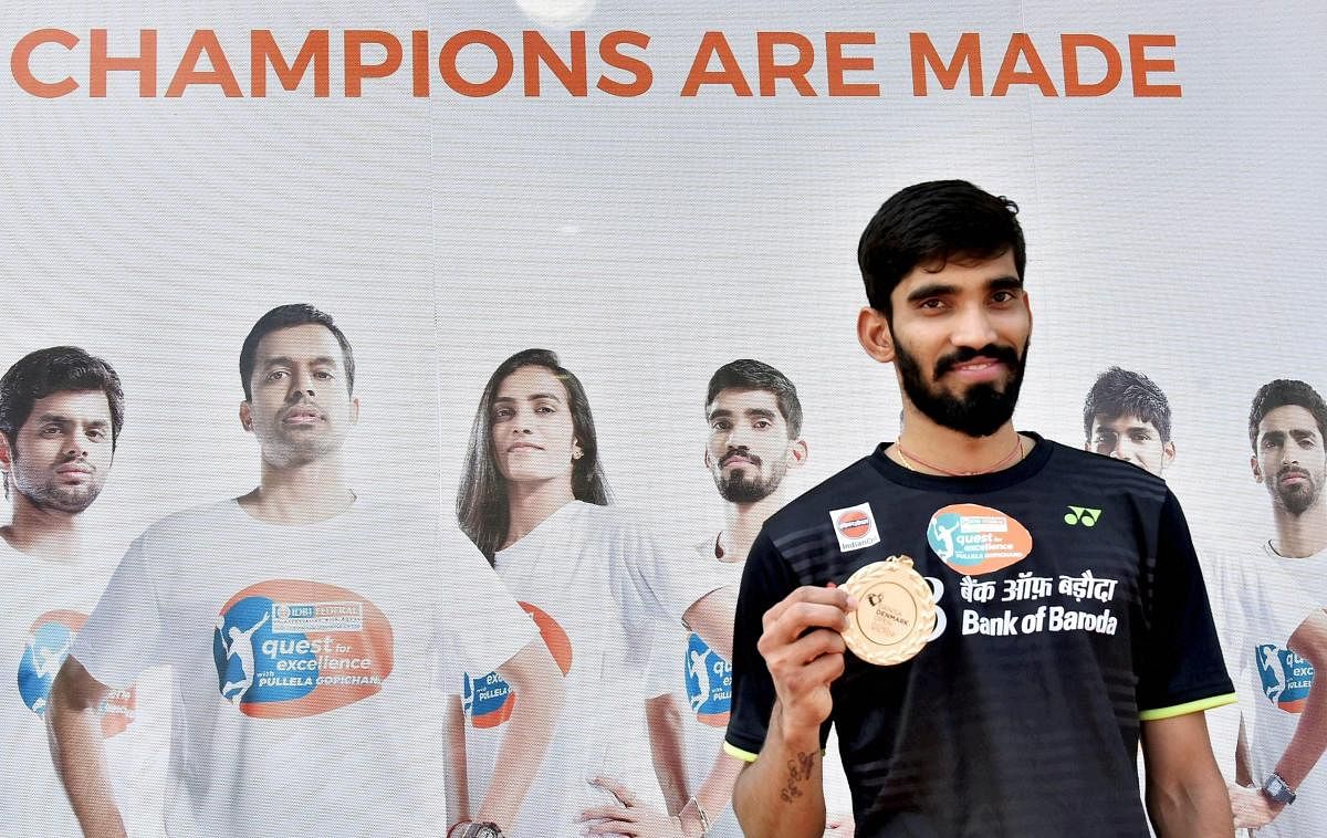 Badminton players Kidambi Srikanth shows his medal that was presented to him after he won Denmark Open Premier Super Series title, at a press conference in Hyderabad on Tuesday. PTI Photo