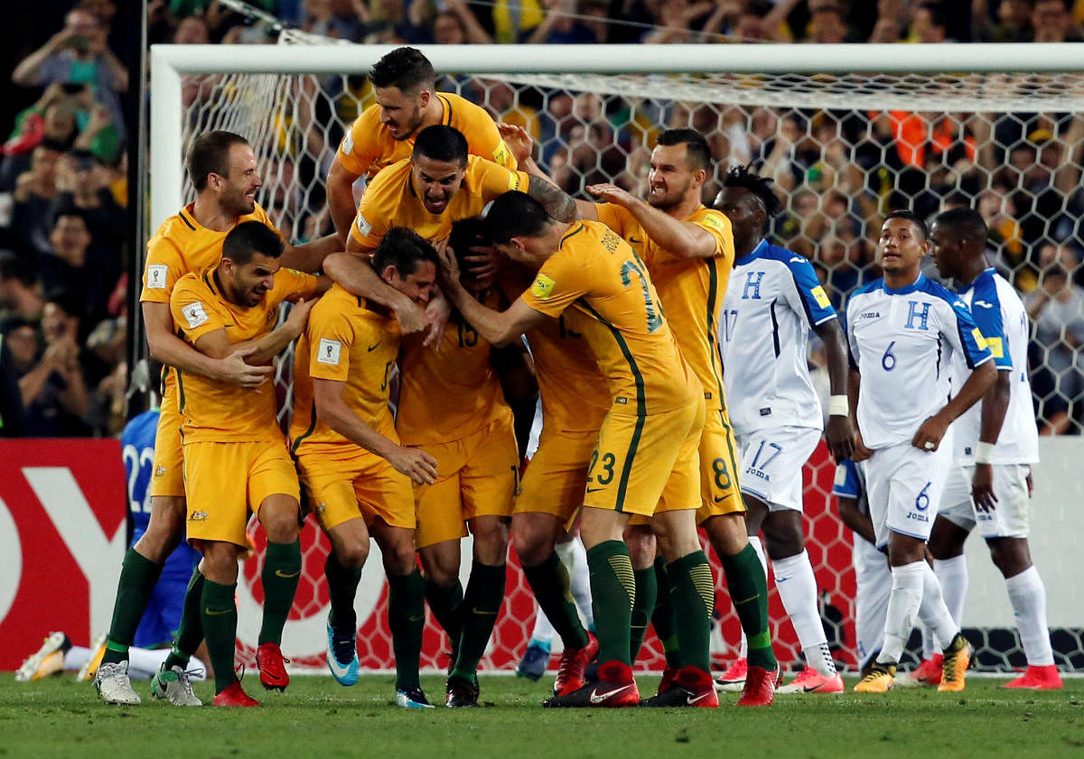 Australian team celebrates after sealing their place at the 2018 FIFA World Cup. Reuters.