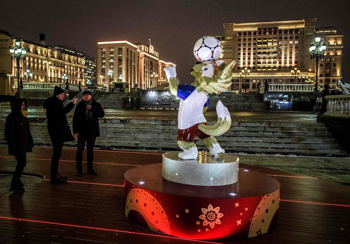 Passers-by take pictures of a figure of Zabivaka, the official mascot for the 2018 FIFA World Cup, at Manezhnaya square in downtown Moscow on Wednesday. AFP