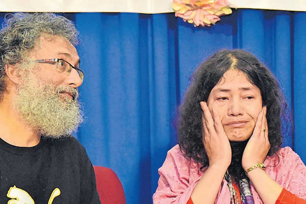 A visibly overwhelmed Irom Chanu Sharmila reacts after being felicitated at St Joseph's College on Friday. Husband Desmond Coutinho is also seen. DH Photo/Janardhan BK