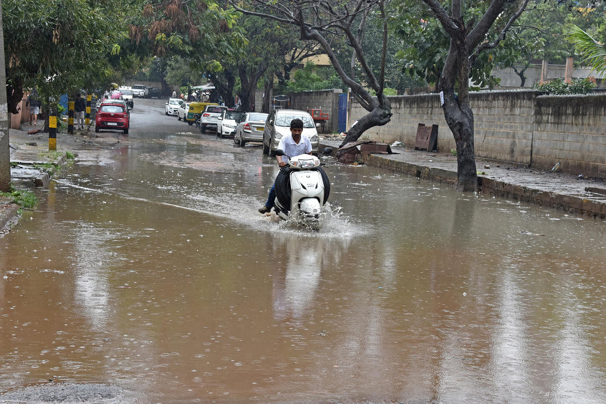 Rain water stagnanted on the road due to rain at Wilson garden, Bengaluru on Friday. Rain in city due to influence of cyclone Ockhi. Photo by S K Dinesh
