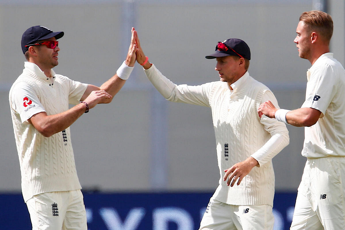 England's James Anderson celebrates with captain Joe Root after dismissing Australia's Mitchell Starc during the second day of the second Ashes cricket test match. REUTERS