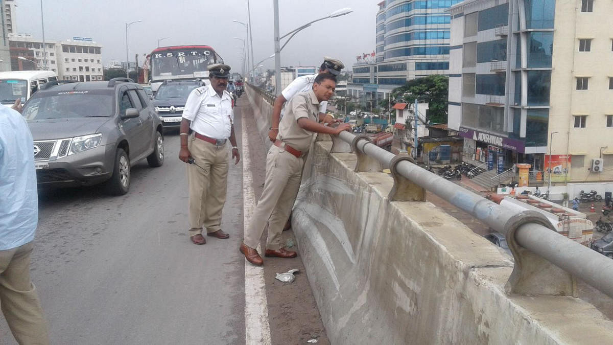 Police officers looking the spot of cab hit the Bike rider and pillion to death on Hosur Road elevated flyover in Bengaluru on Saturday.