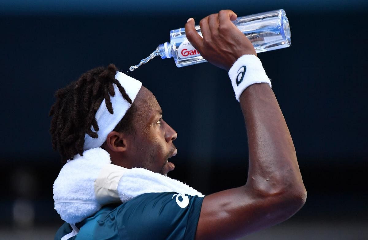 HEAT IS ON France's Gael Monfils cools off with a bottle of water as temperatures touches 40 degrees Celsius on Thursday at the Australian Open. AFP