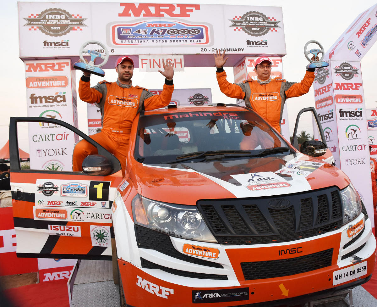 Champion: Team Mahindra's Gaurav Gill (left) and Musa Sherif with trophies after winning the MRF K-1000 rally, the final round of MRF FMSCI INRC rally on Sunday.