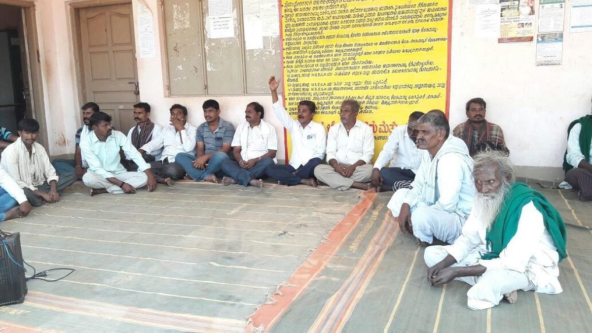 Villagers stage protest in front of Gram Panchayat office at Sulla village in Hubballi taluk on Monday.
