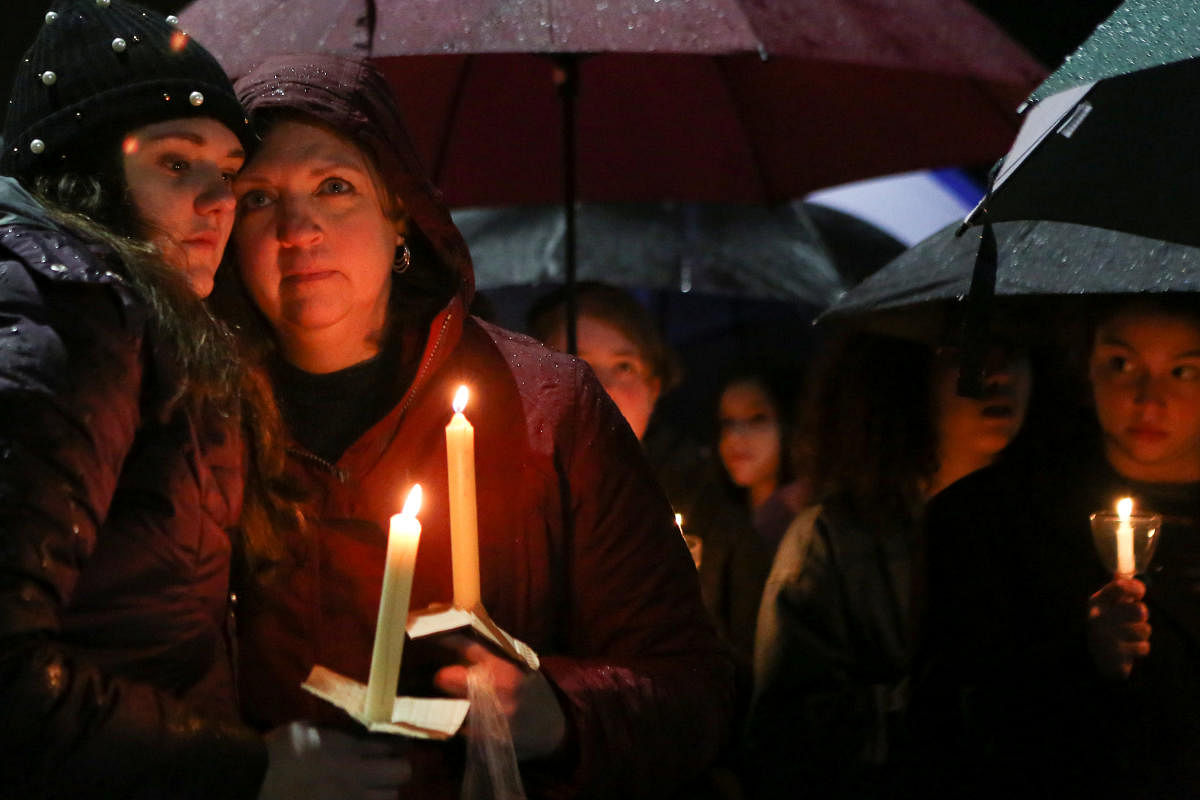 Newtown residents take part in a vigil to mourn students and teachers lost in a mass shooting in Florida. Reuters Photo