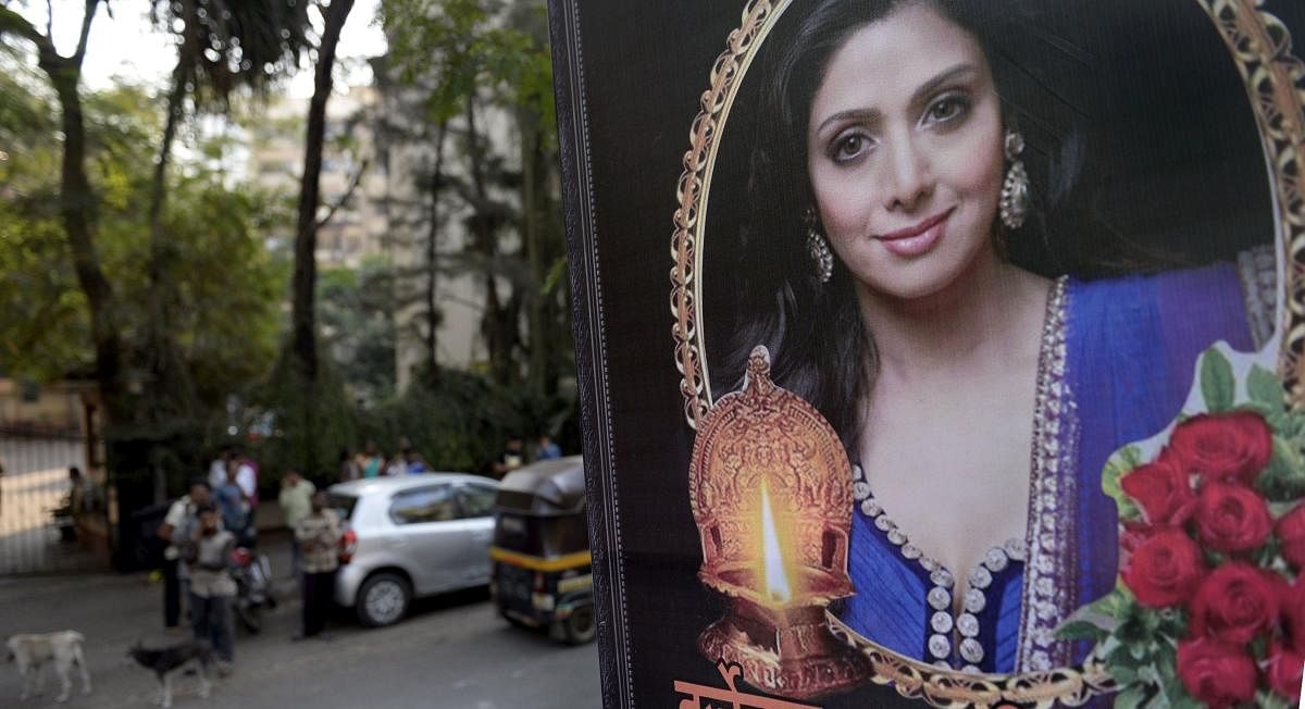 People outside actress Sridevi's residence in Mumbai on Tuesday. PTI Photo