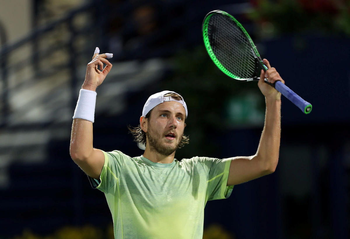 ON A HIGH Lucas Pouille of France celebrates after defeating Filip Krajinovic of Serbia in Dubai. REUTERS