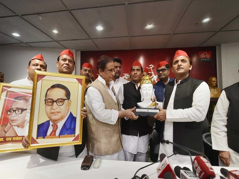 Samajwadi Party President Akhilesh Yadav being presented with a memento by party members during a press conference, at the party headquarters in Lucknow on Saturday. PTI photo