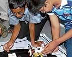 In deep focus: Children at the Robotics camp, launched by Reliance World in association with an IIT-incubated company, in Bangalore on Friday.  DH Photo