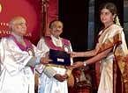 congratulations: Amrutha Venkatesh, topper in BSc, receiving her rank certificate from Governor and Chancellor H R Bhardwaj at the 45th convocation of the Bangalore University on Friday. Vice-chancellor Prof N Prabhu Dev is also seen. dh Photo