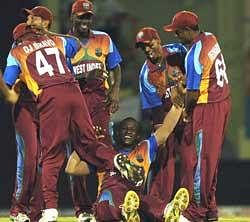 Man of the Match Darren Sammy is greeted by his team mates. AFP