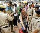 Keeping Vigil: Security personnel check bags of foreign tourists as they enter Janpath market in New Delhi on Saturday. AP