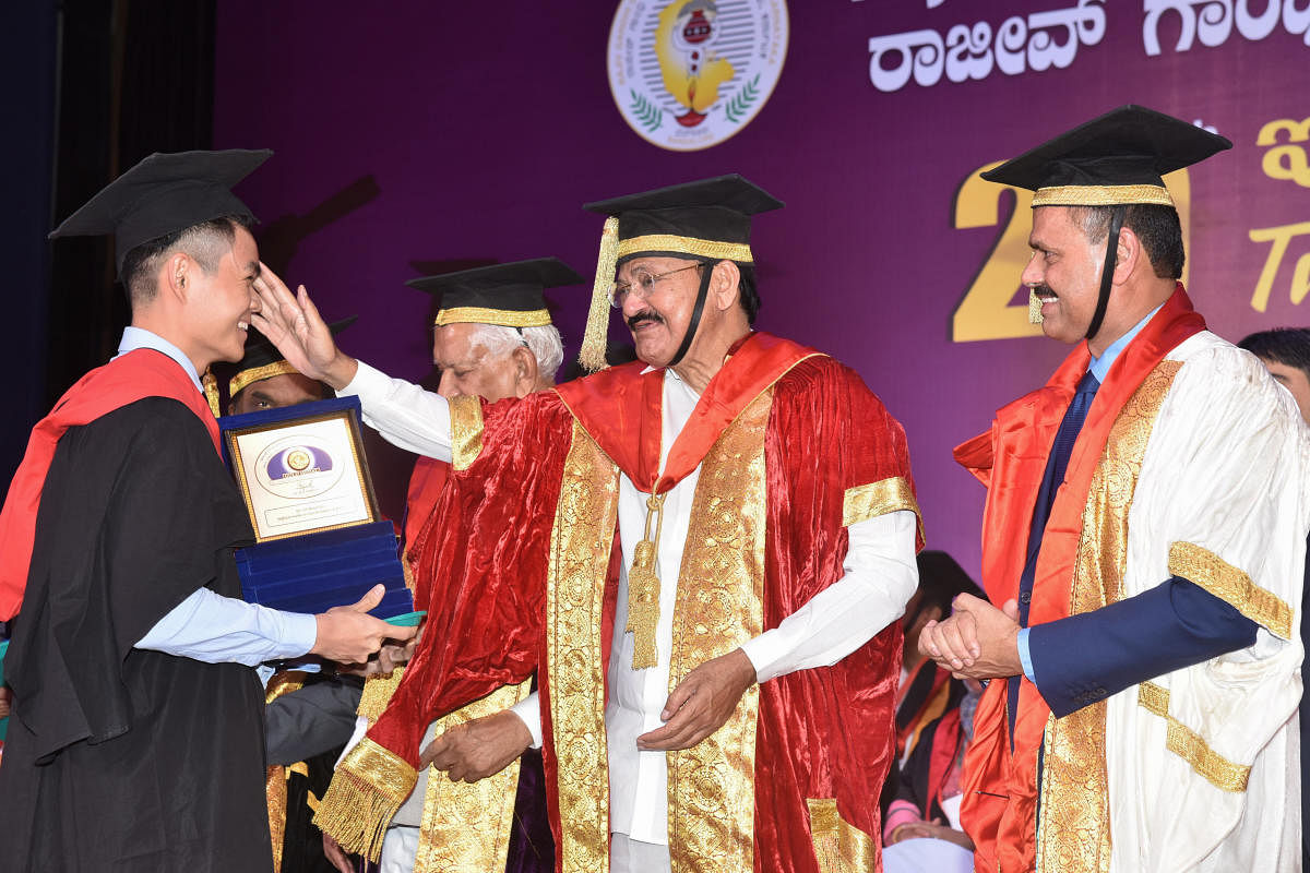 M Venkaiah Naidu, Vice President of India blessing after presenting BDS Course gold medals to Dr Lim Boon Hul of College of Dental Science, Davanagere at Twentieth Annual Convocation of Rajiv Gandhi University of Health Sciences (RGUHS) at NIMHANS Convention Centre in Bengaluru on Thursday. Vajubhai Rudabhai Vala, Governor of Karnataka and Dr M K Ramesh, Vice Chancellor RGUHS are seen. Photo by S K Dinesh