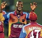 enforcer: West Indies Darren Sammy celebrates the wicket of Boyd Rankin with his team-mate Dwayne Bravo during the World T20 at Providence on Friday. AFP