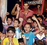 Dilip Singh Rana alias The Great Khali poses with children during the launch of toys at a shop in Mumbai on Saturday. PTI