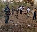 Paramilitary personnel inspecting the site where Naxals blew up a bullet-proof vehicle killing eight CRPF jawans, in Bijapur district of Chhattisgarh on Saturday. PTI