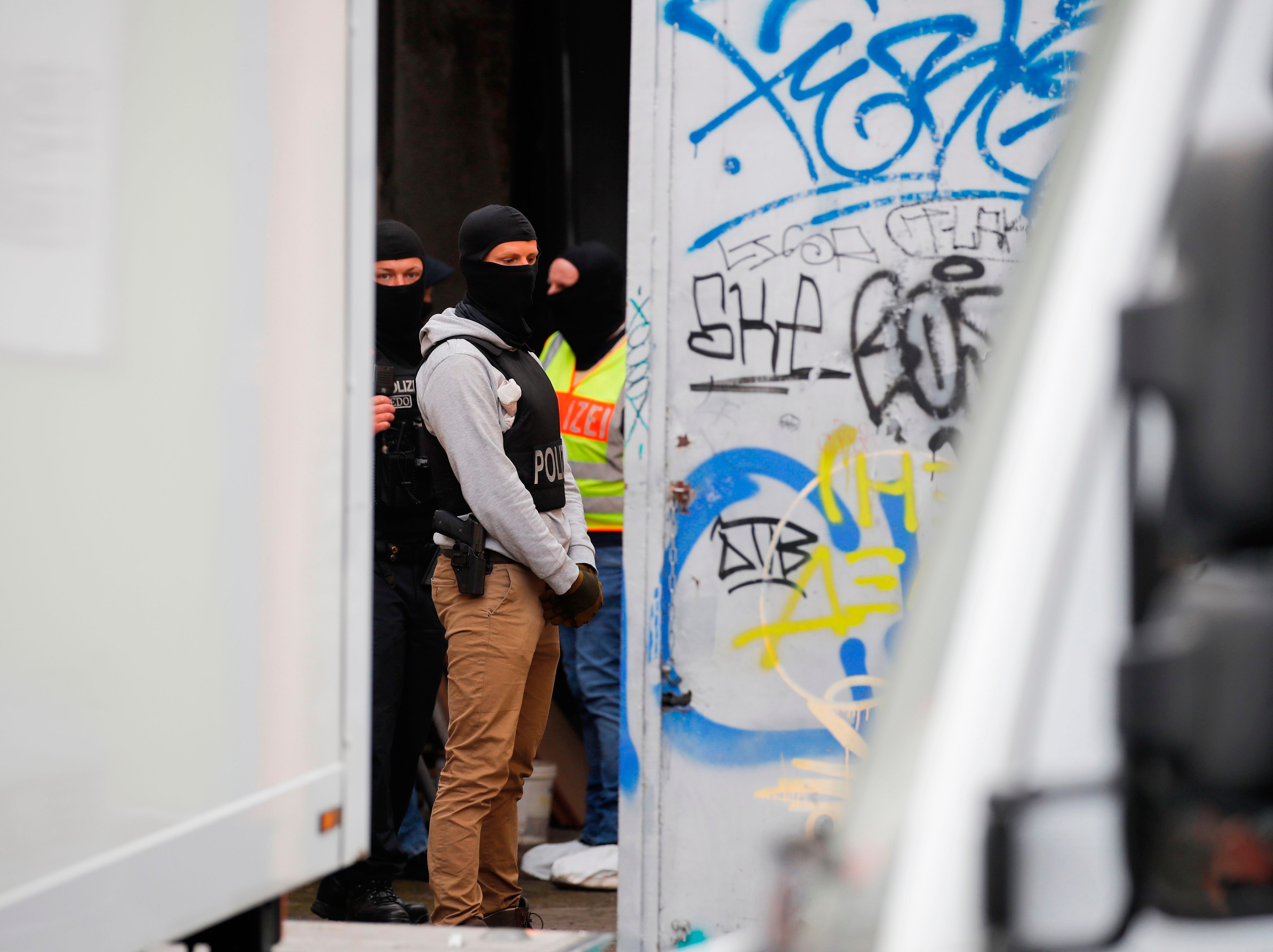 Police stand in the backyard of Al-Irschad Mosque during a raid on April 30, 2020 in Berlin, as dozens of police and special forces stormed mosques and associations linked to Hezbollah in Bremen, Berlin, Dortmund and Muenster in the early hours of the morning. (AFP)
