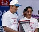 Union Health Minister Ghulam Nabi Azad felicitates badminton player Saina Nehwal during a function organized on the occasion on 'World Population Day' at Rajpath in New Delhi on Sunday. PTI