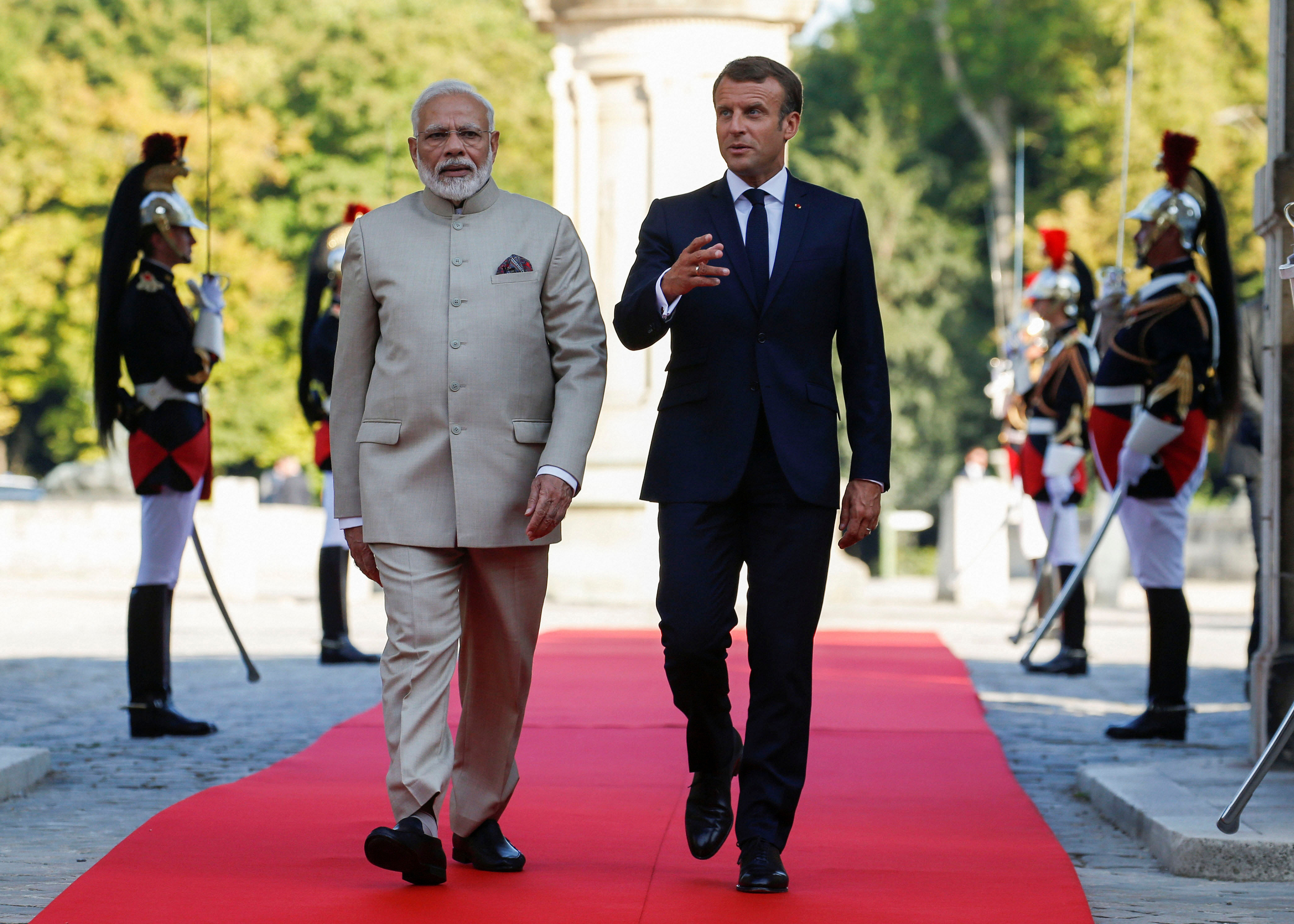 French President Emmanuel Macron, right, welcomes Indian Prime Minister Narendra Modi. (AP Photo)