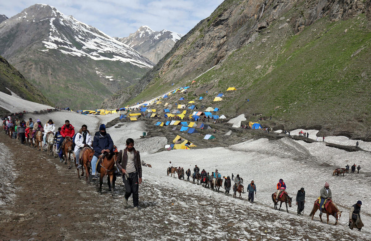 Pilgrims treck through mountains to reach the Amarnath cave shrine. Photo credit: Reuters