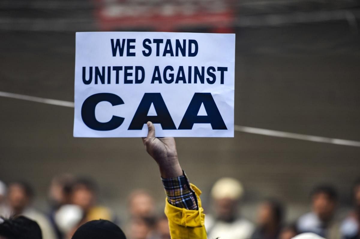  A protestor holds a placard during a demonstration against the Citizenship Amendment Act (CAA). (PTI file photo)