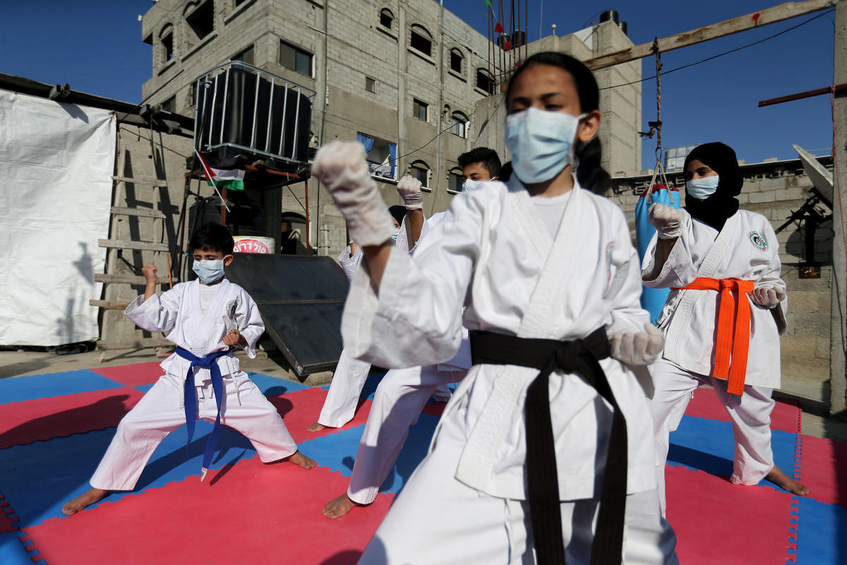 Palestinian family participates in Karate training session on their home rooftop, amid concerns about the spread of the coronavirus disease (COVID-19), in the southern Gaza Strip. Credit: Reuters Photo