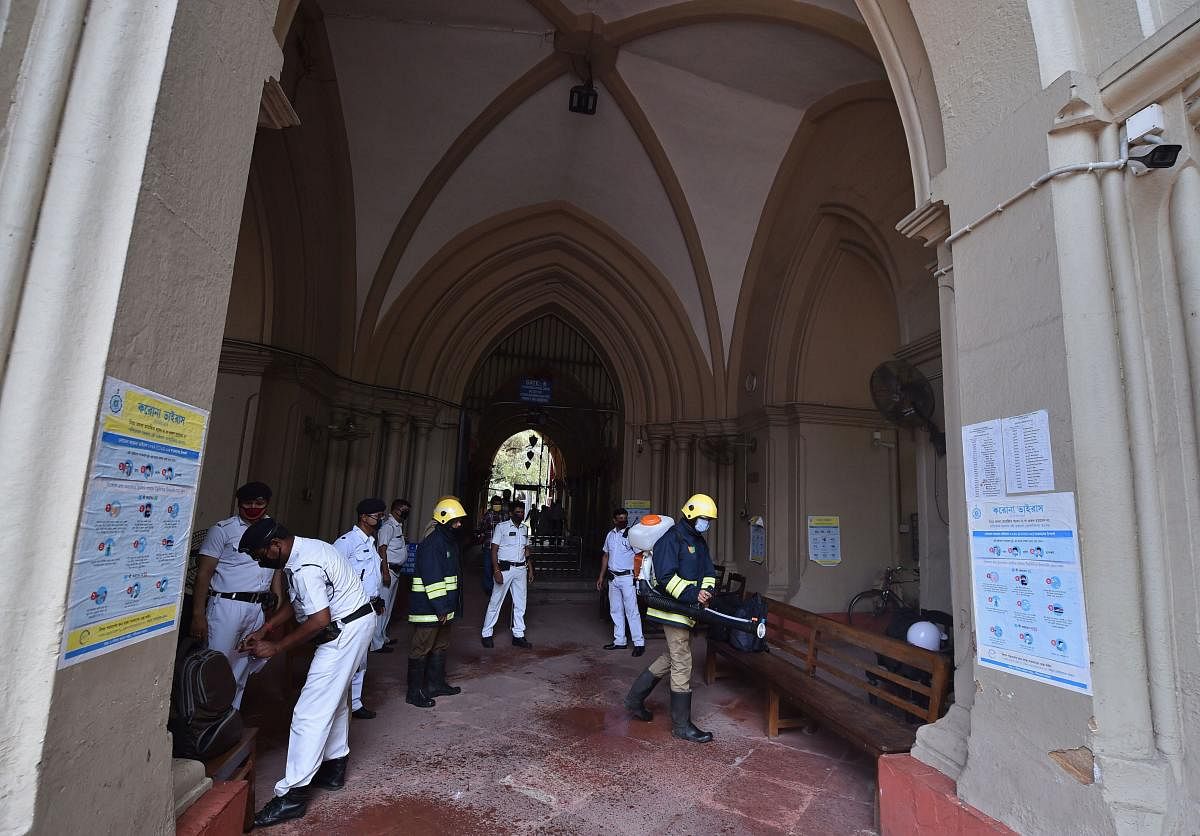 Firefighters spray disinfectant at Calcutta High Court (PTI Photo)