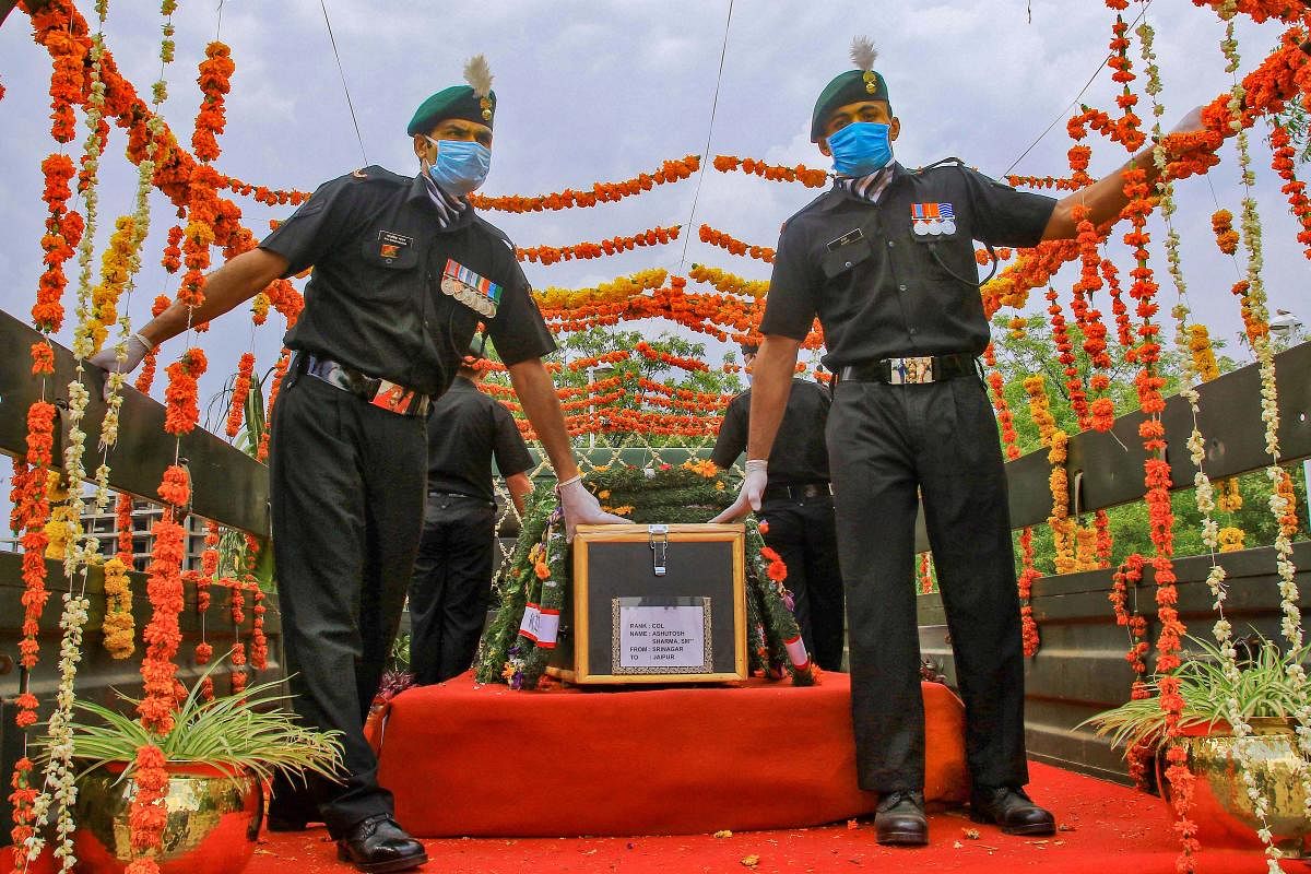 A coffin containing the mortal remains of Colonel Ashutosh Sharma, who was martyred in the Handwara encounter late Saturday, arrives at the airport, in Jaipur, Monday, May 4, 2020. Two senior army officers, a colonel and a major, were among five security personnel martyred in the encounter. (PTI Photo)