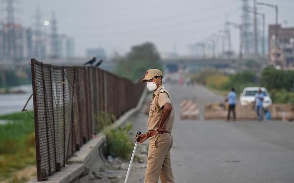 A policeman wearing a mask stands guard on a road at Ghazipur during the nationwide lockdown, imposed in wake of the coronavirus pandemic, in New Delhi, Monday, April 27, 2020. (PTI Photo/Atul Yadav)