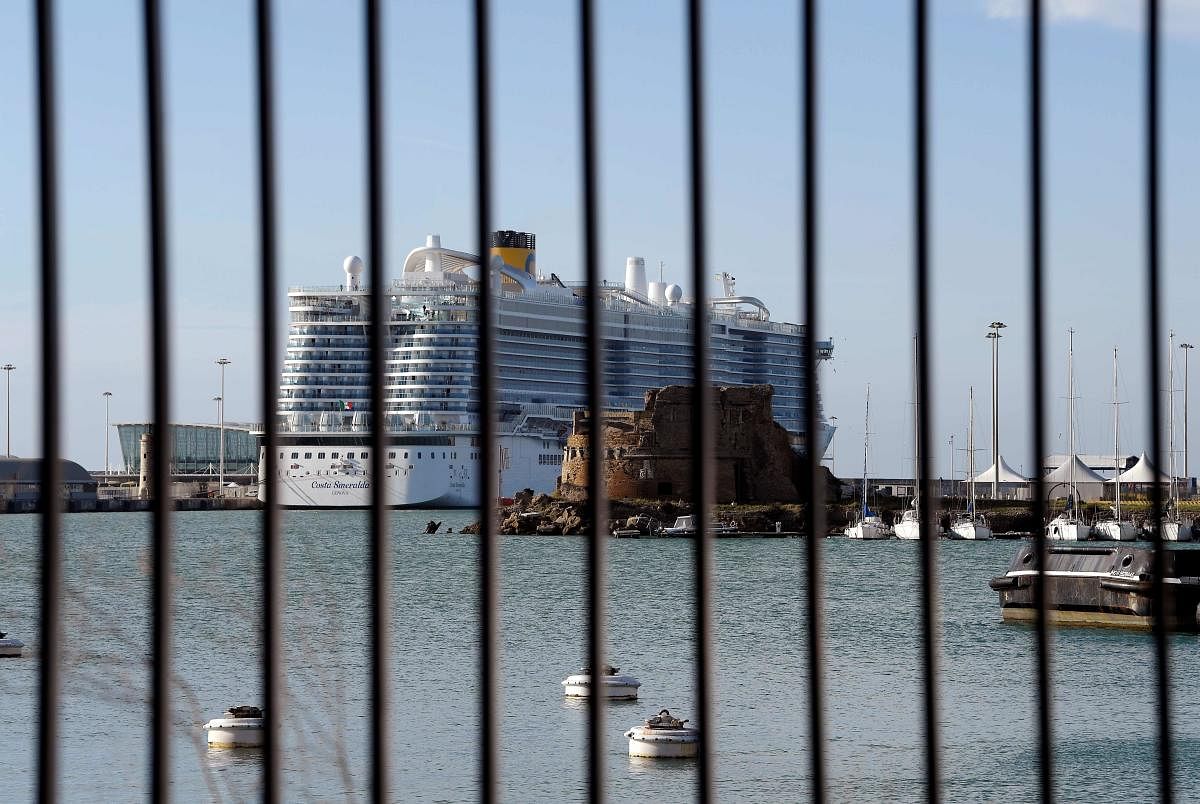 The Costa Smeralda cruise ship is seen behind a fence at it is docked in the Civitavecchia port 70km north of Rome on January 30, 2020. - More than 6,000 tourists were under lockdown aboard the cruise ship after two Chinese passengers were isolated over fears they could be carrying the coronavirus. AFP