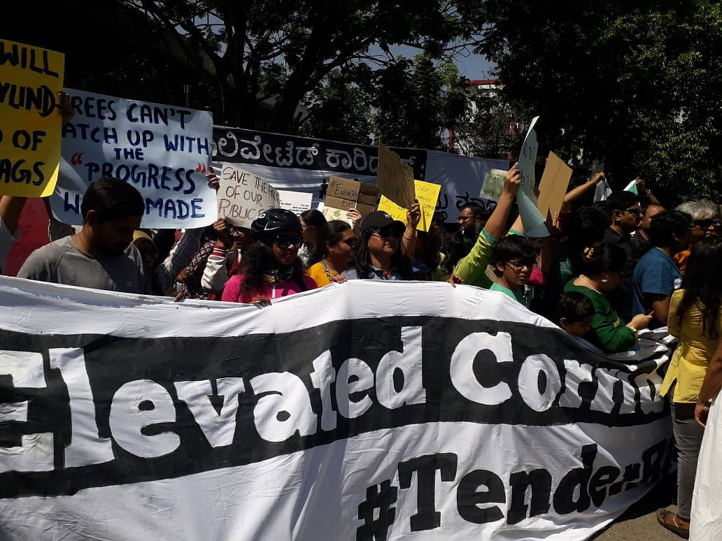  The protest received massive support with at least 1,500  people participating in the event so far on Saturday morning at the Maurya Circle behind the Race Course. More than 50  RWA members staged a demonstration demanding cancellation of the tenders for the controversial project under the hashtag #TenderRadduMaadi (Cancel the Tender). DH photo