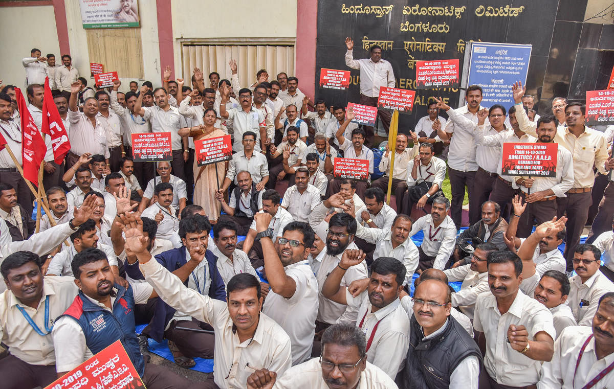 HAL employees, under the banner of the All India HAL Trade Unions Coordination Committee, staged an indefinite strike in front of the factory on Monday. DH Photo/S K Dinesh