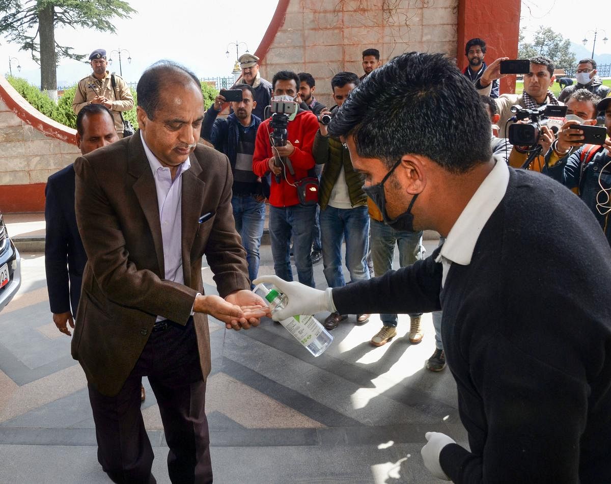  Himachal Pradesh Chief Minister Jai Ram Thakur uses hand sanitizer before going to attend all party meeting, in Shimla, Saturday, March 21, 2020. (PTI Photo)