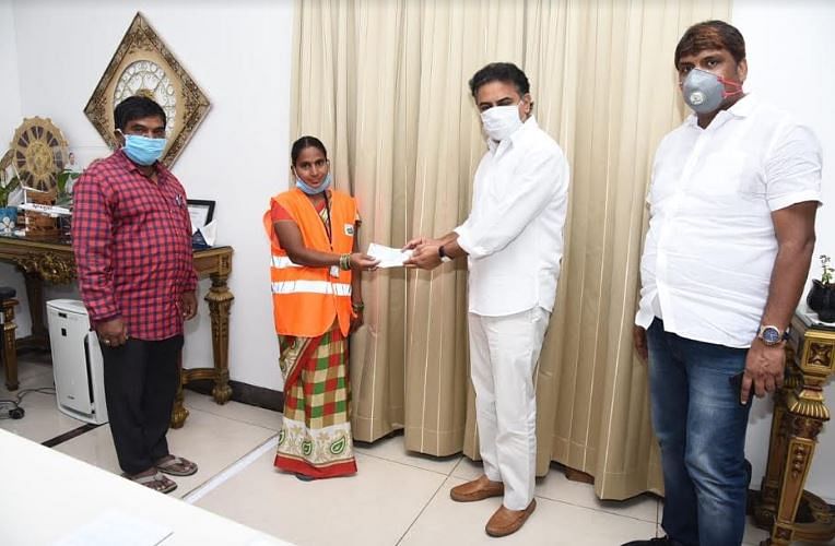 Hyderabad sanitation worker Yedumekala Alivelu hand-over check to Telangana minister KT Rama Rao for COVID-19 fund