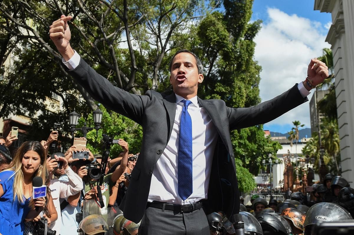Juan Guaido shouts gestures on his way to the National Assembly, Caracas. AFP