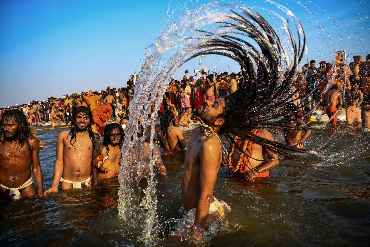  Indian sadhus (Hindu holy men) take a dip into the water of the holy Sangam during the auspicious bathing day of Makar Sankranti at the Kumbh Mela in Allahabad. AFP photo