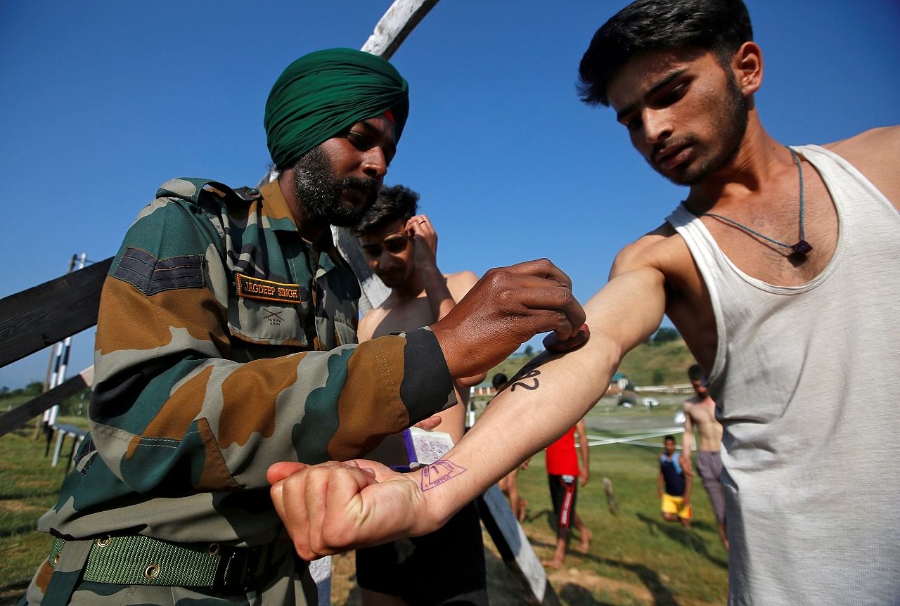 An army soldier stamps the arm of a Kashmiri youth during a recruitment drive organized by the Indian army in Pattan, north of Srinagar, earlier this month (PTI File Photo)