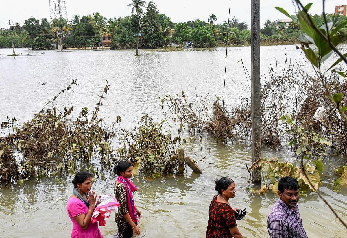 People in the flood-affected Manjali at North Paravoor in Kochi on Monday, Aug 20, 2018. (PTI Photo) 