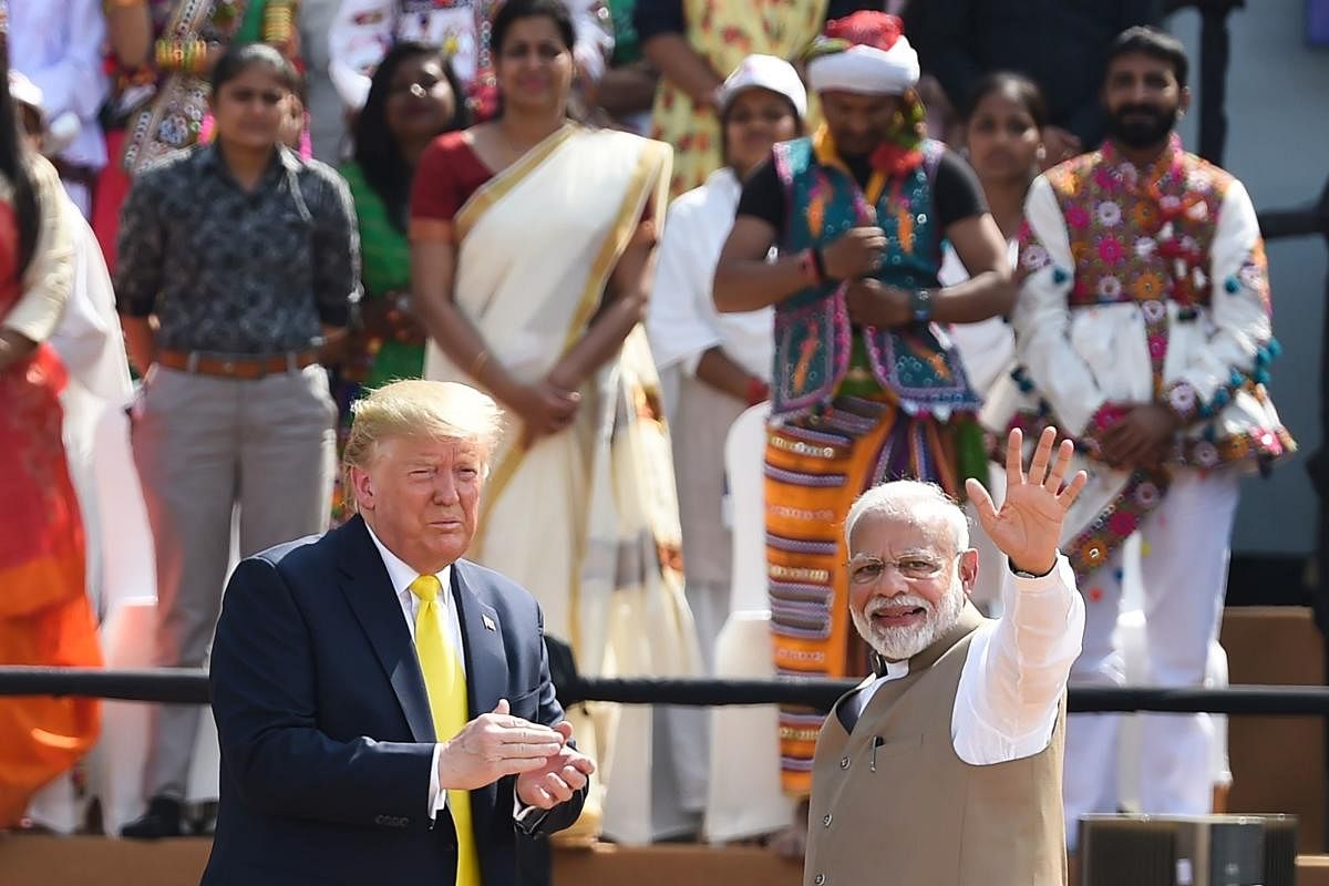 India's Prime Minister Narendra Modi (R) and US President Donald Trump greet the crowd during 'Namaste Trump' rally at Sardar Patel Stadium in Motera, on the outskirts of Ahmedabad, on February 24, 2020. (Photo by Money SHARMA / AFP)