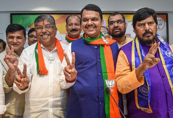 Maharashtra Chief Minister Devendra Fadnavis, State BJP president Chandrakant Patil and RPI chief Ramdas Athawale flash victory signs as they celebrate their win in Maharashtra Assembly elections, in Mumbai. (PTI photo)