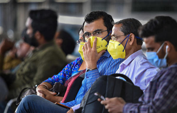Passengers wear masks to mitigate the coronavirus pandemic, at Chennai Airport, Tuesday, March 24, 2020. (Credit: PTI Photo/R Senthil Kumar)