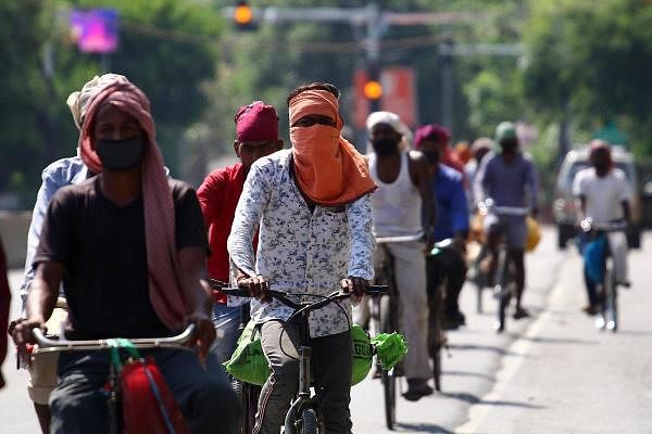 Migrant labourers cycle as they going to Patna from Delhi during a government-imposed nationwide lockdown as a preventive measure against the spread of the COVID-19 coronavirus, in Allahabad, on May 5, 2020. (AFP Photo by Sanjay Kanojia)