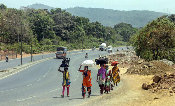 Migrant workers and their family members walk on the national highway to reach their native place in Jalgaon district of Maharashtra, during a nationwide lockdown, in the wake of coronavirus, in Mira Bhayandar area of Mumbai, Thursday, April 30, 2020. (PTI Photo)